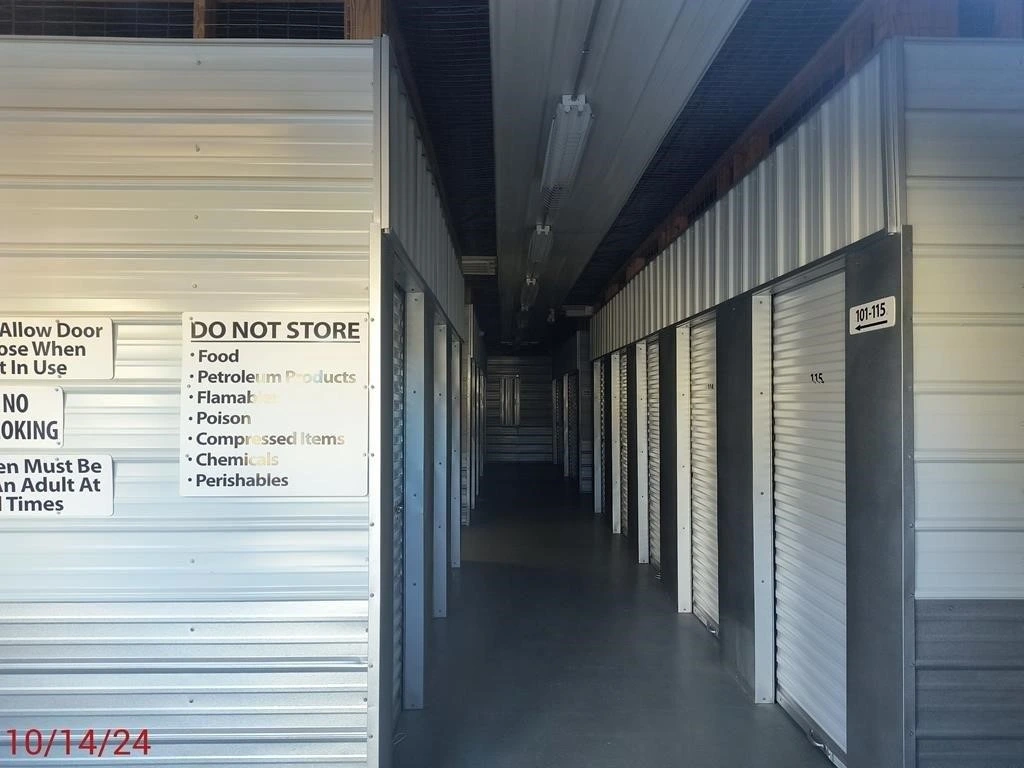 Interior view of a self-storage unit featuring various organizational signs on the walls Interior view of a self-storage unit featuring various organizational signs on the walls.